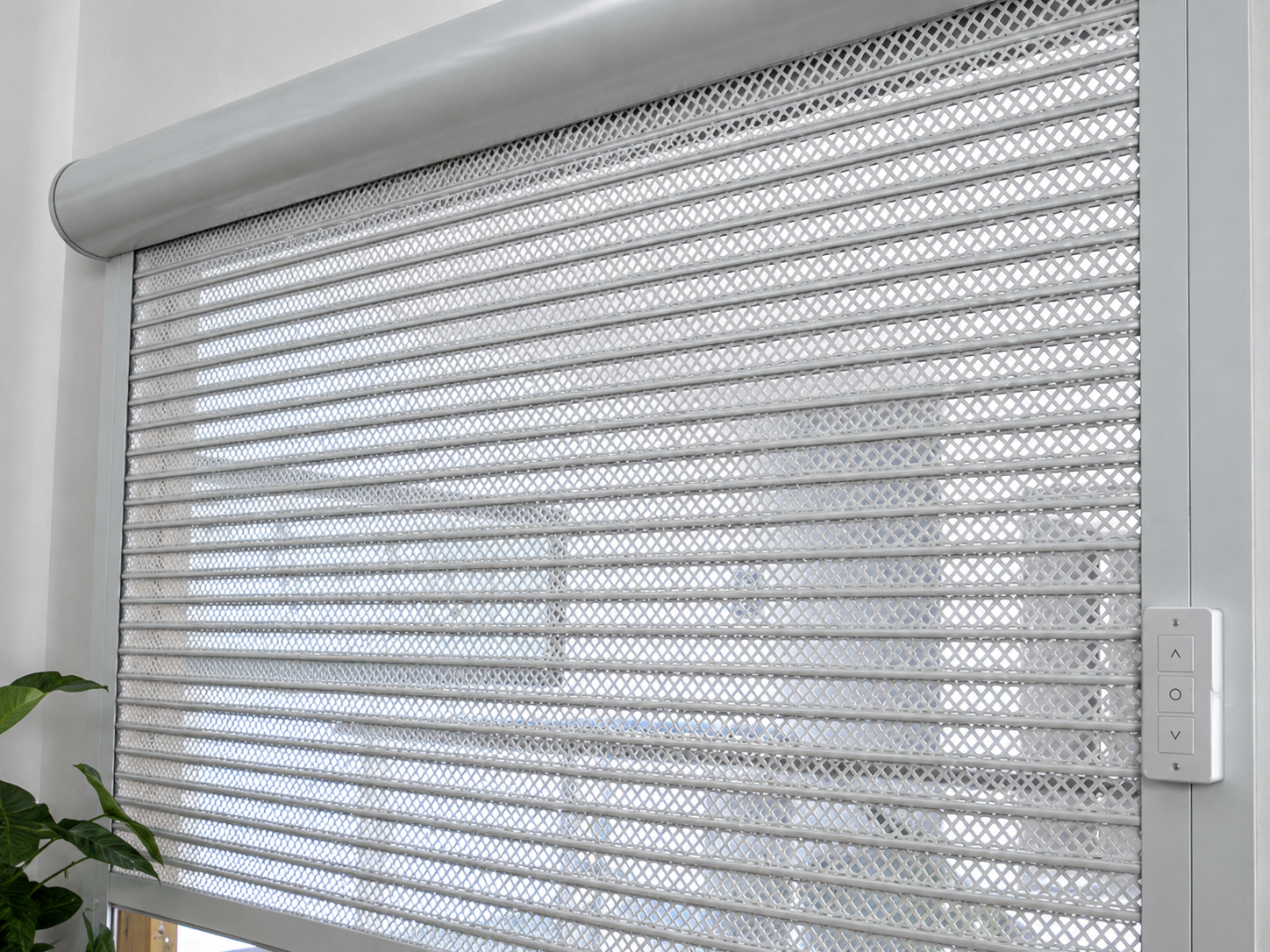 Perforated rolling shutter motorised drive and control installation — operational view